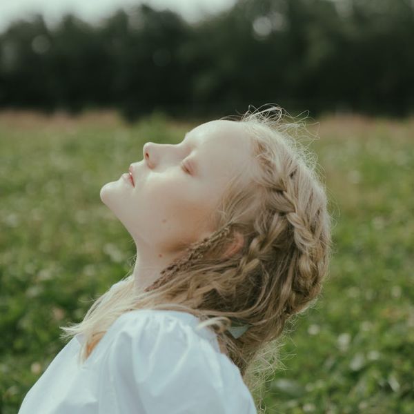Side profile of a person with closed eyes, breathing deeply.